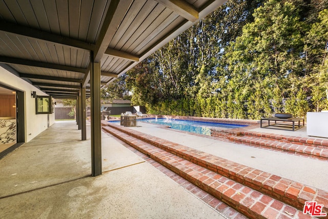 view of swimming pool with a patio area