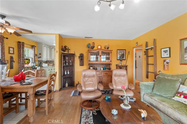 living room with ceiling fan and light hardwood / wood-style floors