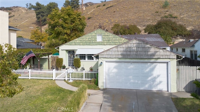 view of front of property with a garage and a mountain view