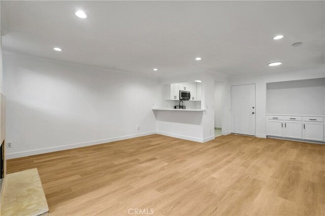 unfurnished living room with light hardwood / wood-style flooring