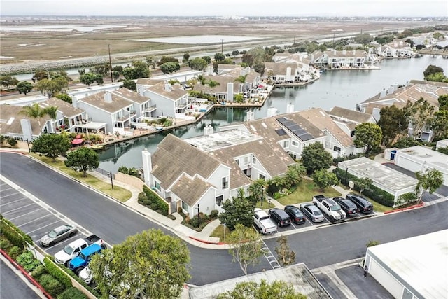 birds eye view of property featuring a water view and a residential view