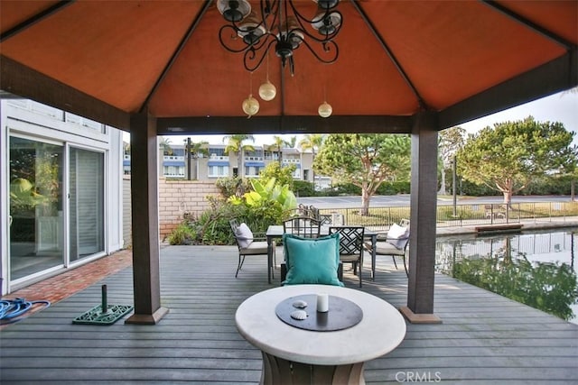 deck with outdoor dining space and a gazebo