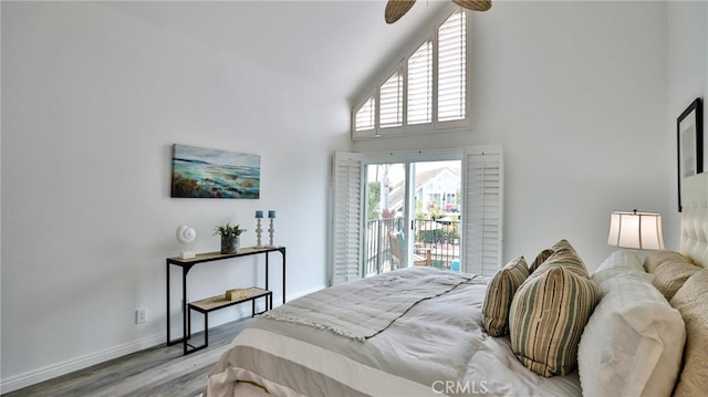 bedroom with baseboards, a ceiling fan, wood finished floors, access to exterior, and high vaulted ceiling