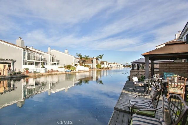 dock area with a residential view and a water view