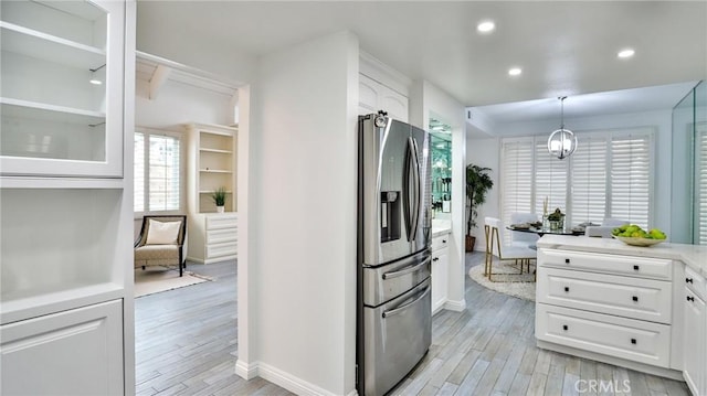 kitchen featuring light wood finished floors, recessed lighting, white cabinets, and stainless steel fridge with ice dispenser