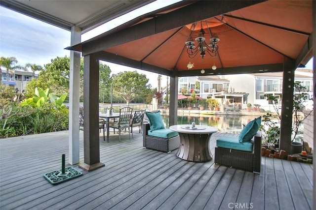 deck with a gazebo and outdoor dining area