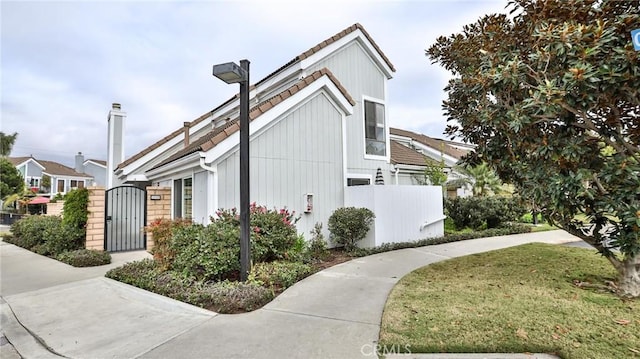 view of front of home featuring a front yard, a gate, and fence