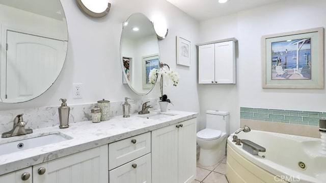 bathroom with toilet, a jetted tub, a sink, and tile patterned floors