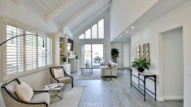 sitting room with high vaulted ceiling, wood finished floors, beam ceiling, and baseboards