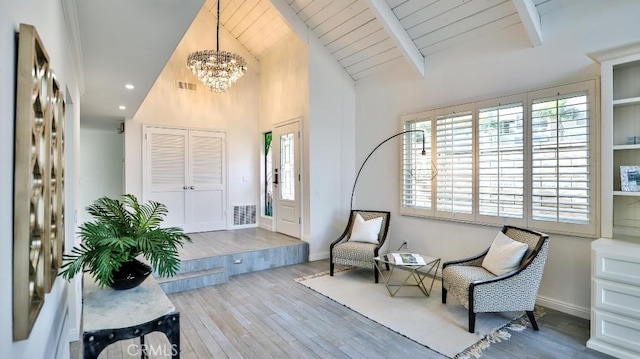 living area featuring wood ceiling, wood finished floors, visible vents, and baseboards