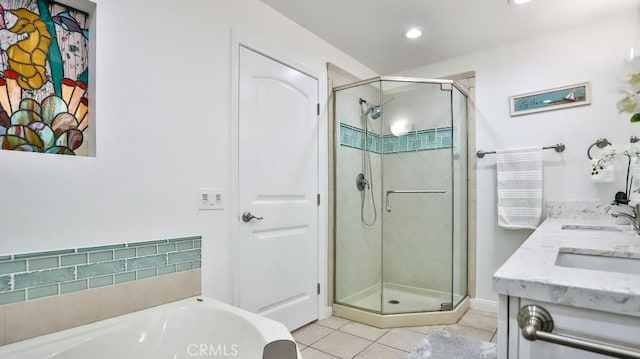 full bath with a garden tub, a sink, tile patterned flooring, and a shower stall