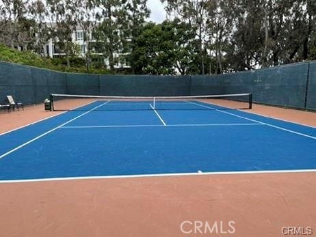 view of tennis court featuring basketball hoop