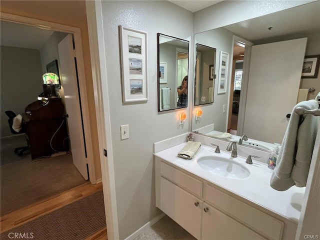 bathroom featuring vanity and hardwood / wood-style floors