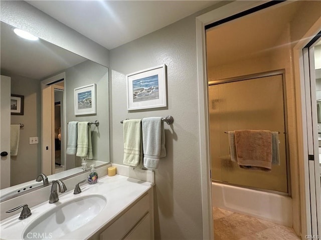 bathroom with enclosed tub / shower combo and vanity