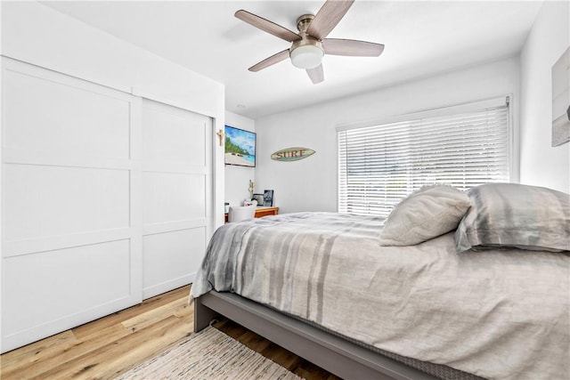 bedroom with ceiling fan and light hardwood / wood-style floors