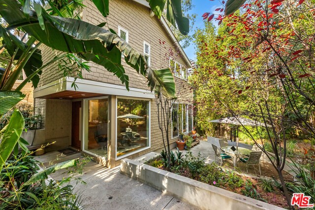 view of property exterior with a patio