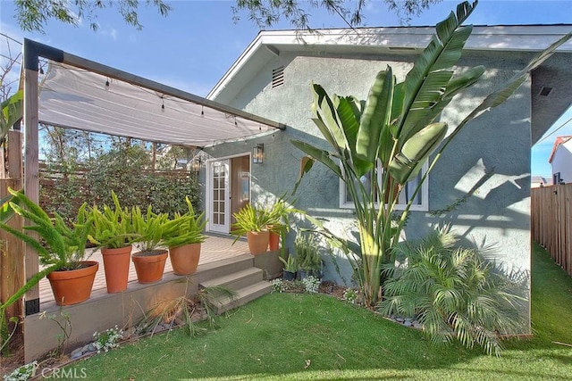 exterior space with a wooden deck and a lawn