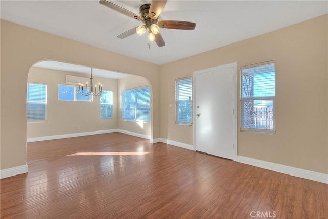 foyer entrance featuring dark hardwood / wood-style flooring and ceiling fan with notable chandelier