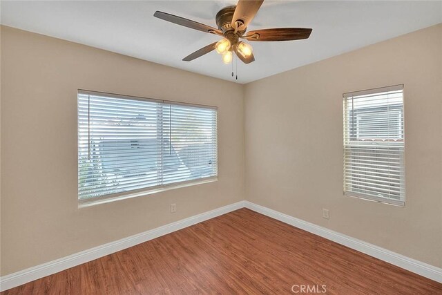 spare room featuring ceiling fan and hardwood / wood-style floors