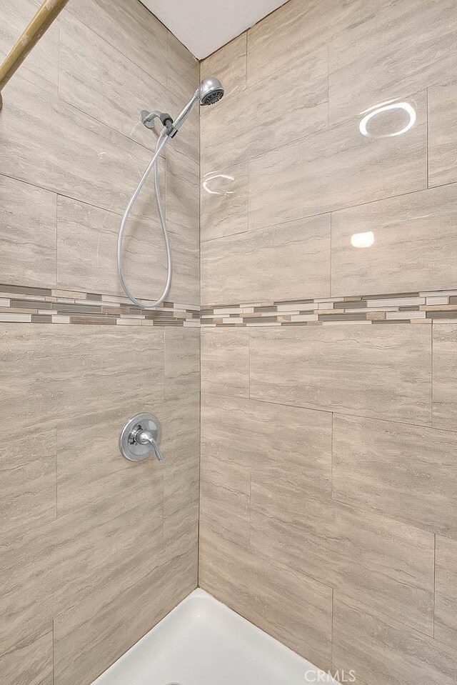 bathroom with tiled shower