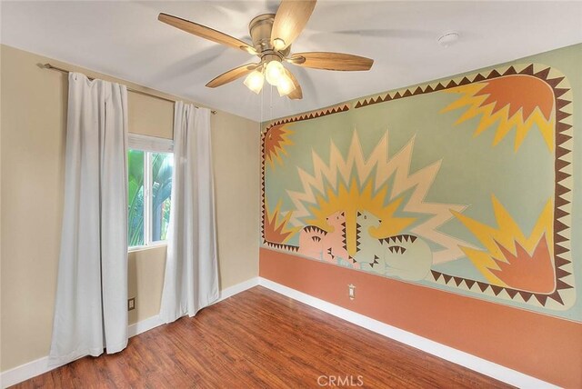 unfurnished room with ceiling fan and hardwood / wood-style flooring