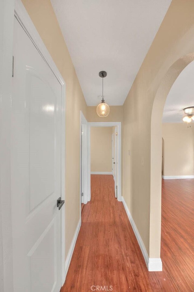 hallway with light hardwood / wood-style floors