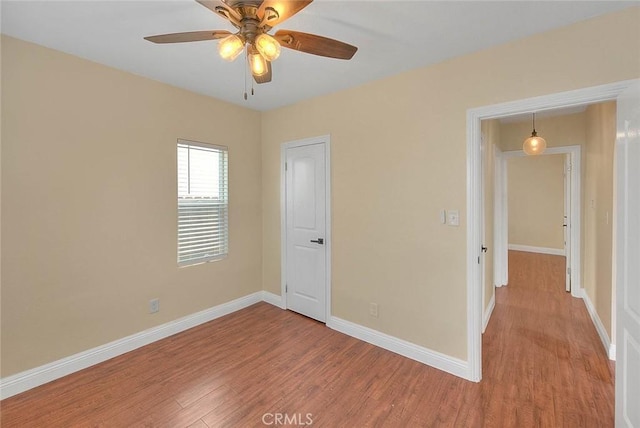 unfurnished room featuring ceiling fan and hardwood / wood-style flooring