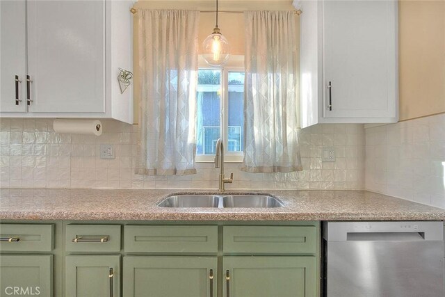 kitchen featuring white cabinets, decorative light fixtures, tasteful backsplash, sink, and stainless steel dishwasher