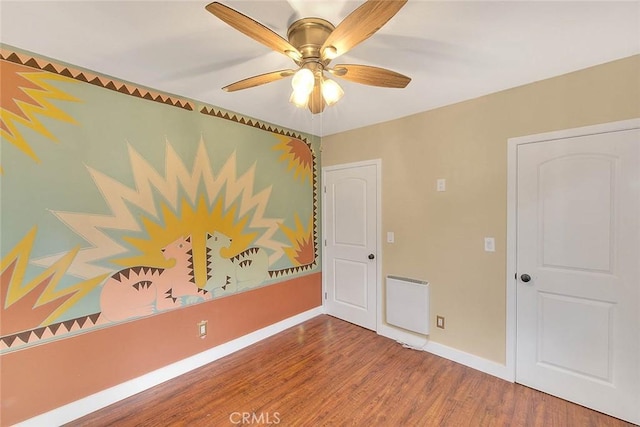 empty room featuring ceiling fan and hardwood / wood-style flooring