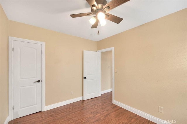 unfurnished room with ceiling fan and hardwood / wood-style flooring