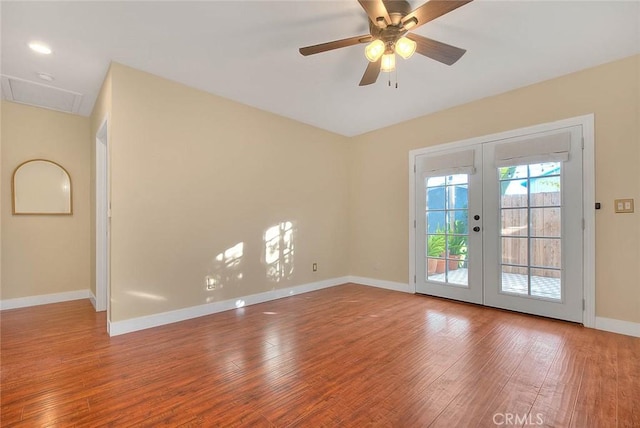 spare room with ceiling fan, french doors, and hardwood / wood-style floors