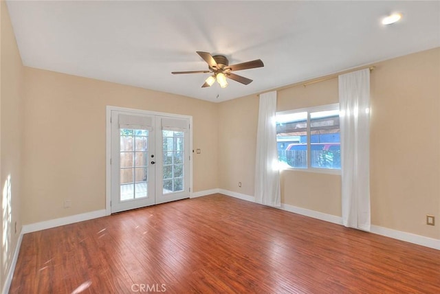 unfurnished room featuring ceiling fan, french doors, and hardwood / wood-style floors