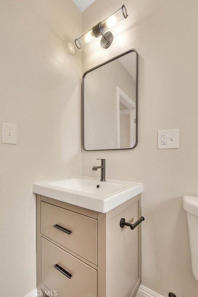 bathroom featuring toilet and vanity