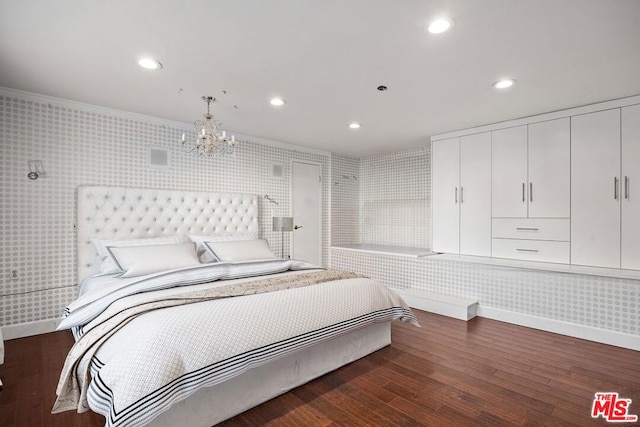 bedroom with dark hardwood / wood-style floors, crown molding, and a notable chandelier