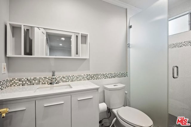 bathroom with toilet, tile walls, walk in shower, ornamental molding, and vanity