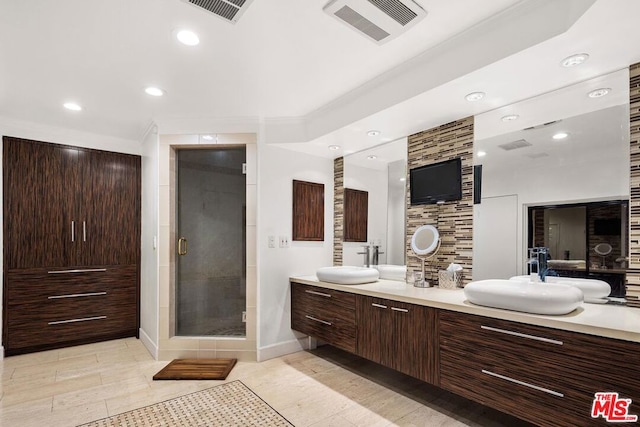 bathroom with a shower with door and vanity