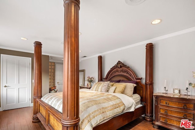 bedroom with dark hardwood / wood-style floors and ornamental molding