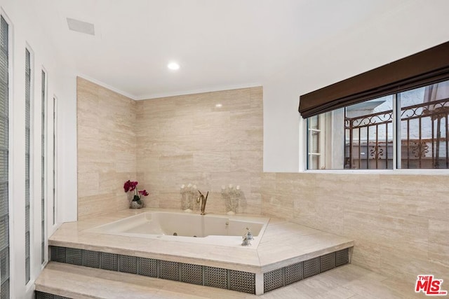 bathroom with tile walls and tiled tub