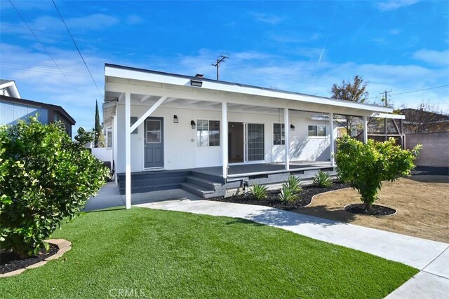 bungalow featuring a front yard and a porch