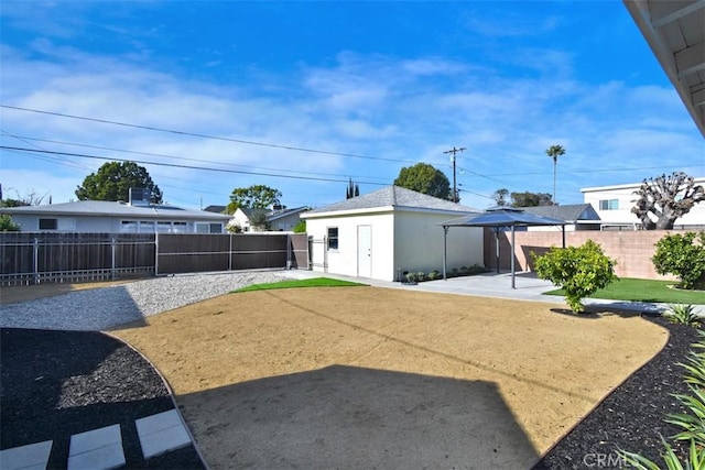 view of yard featuring an outbuilding and a patio area