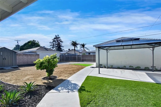 view of yard with a gazebo and a storage shed