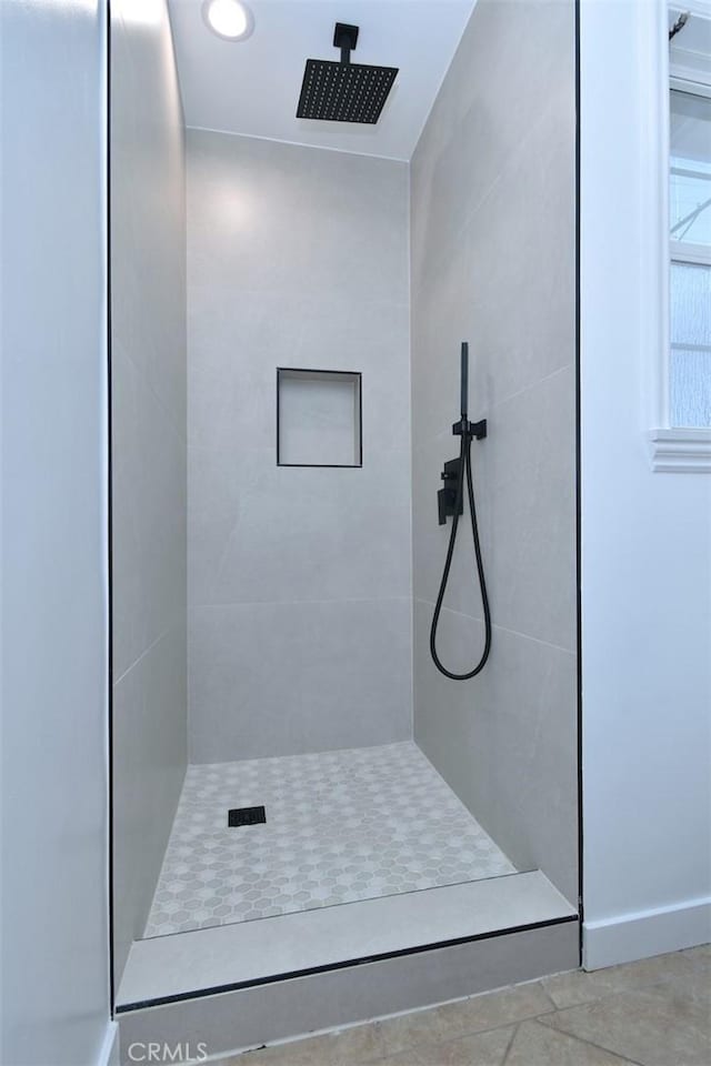 bathroom with a tile shower