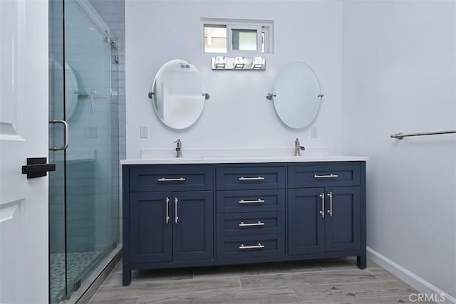 bathroom featuring vanity and an enclosed shower