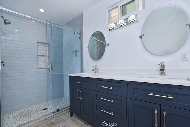 bathroom featuring vanity and an enclosed shower