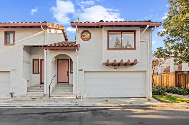 mediterranean / spanish-style house with a garage