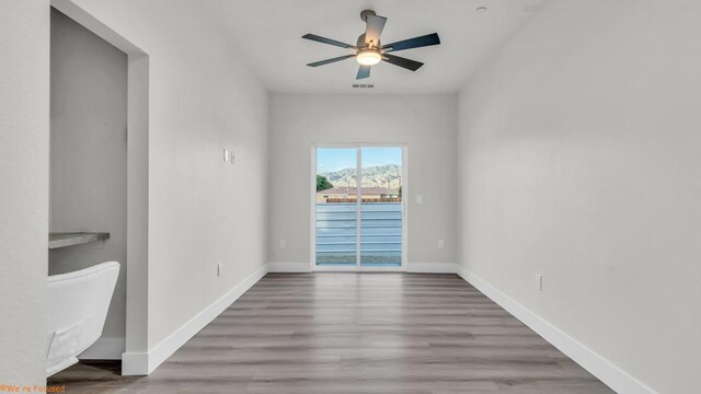 spare room featuring ceiling fan and hardwood / wood-style flooring