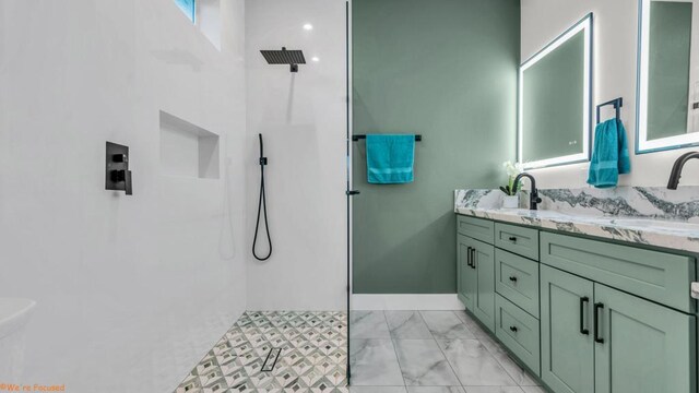 bathroom featuring walk in shower and vanity