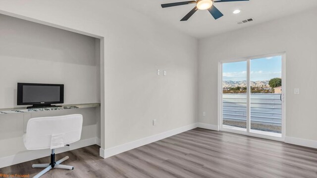 unfurnished office featuring ceiling fan and hardwood / wood-style flooring