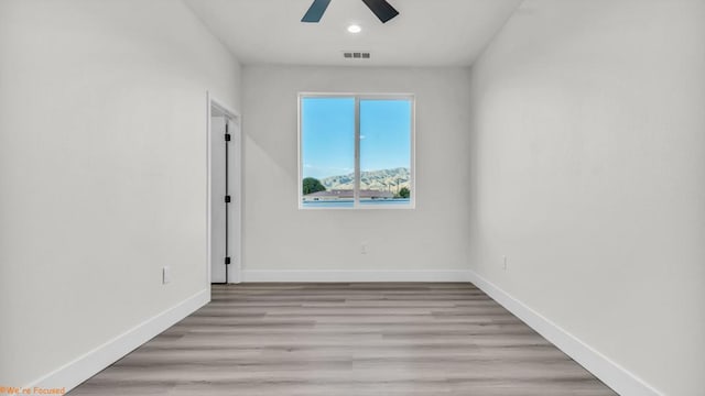 spare room featuring ceiling fan and light hardwood / wood-style flooring