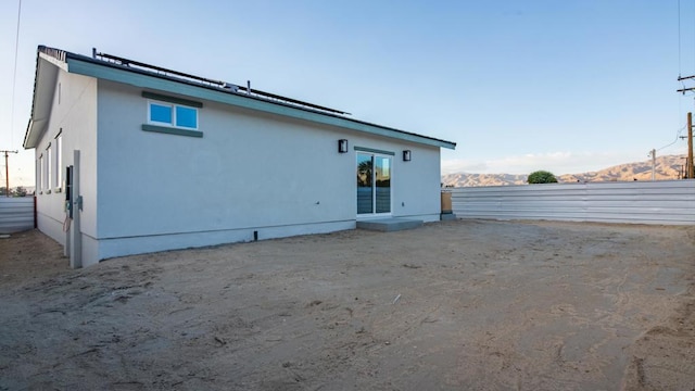 back of house featuring a mountain view